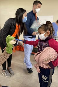 Girl in mask brush's puppets teeth