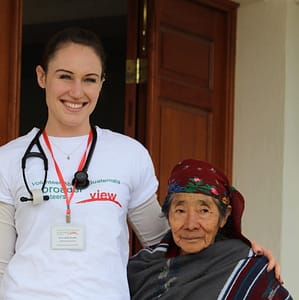 Woman with stethoscope and older woman look at camera